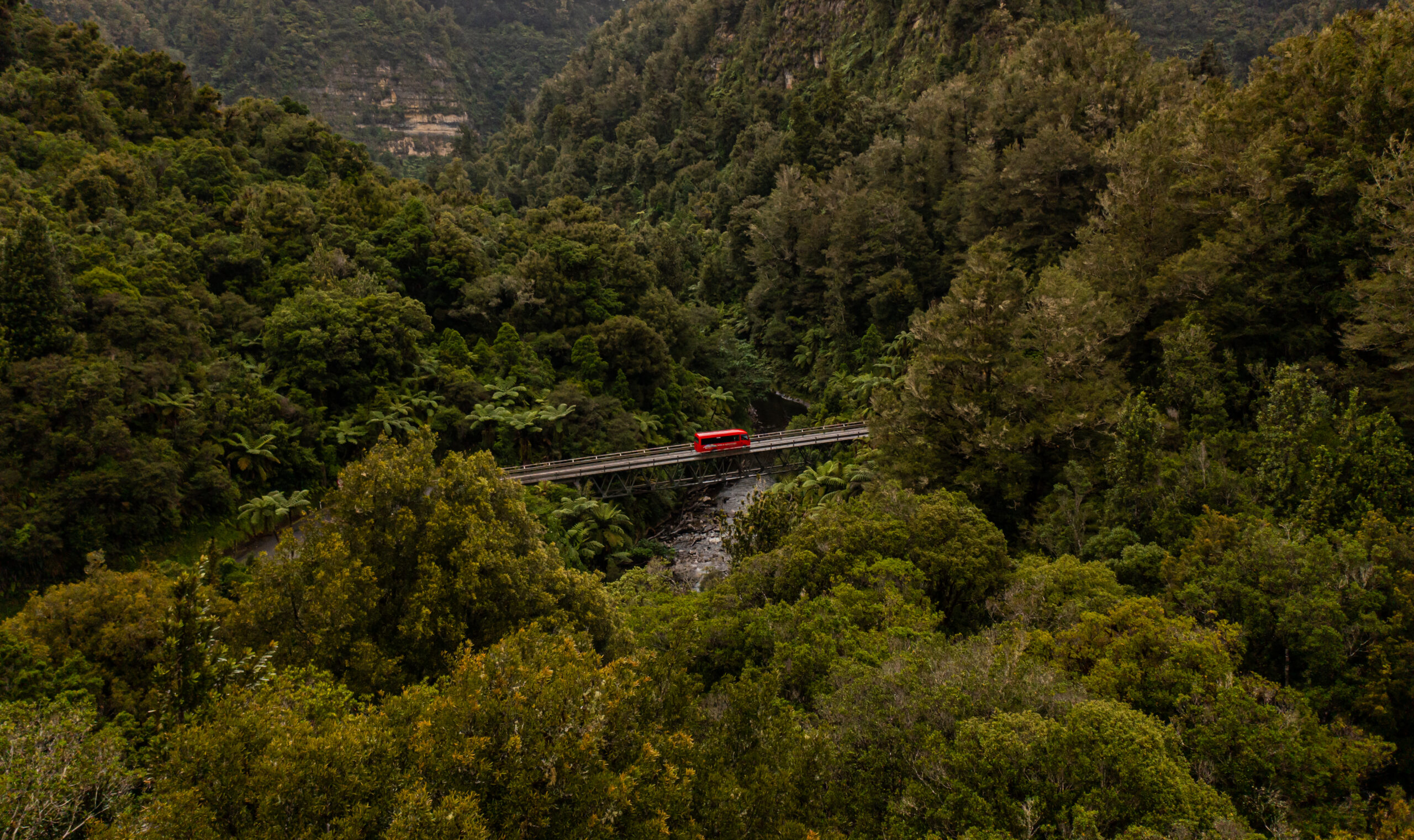 Red FWA bus in valley scaled